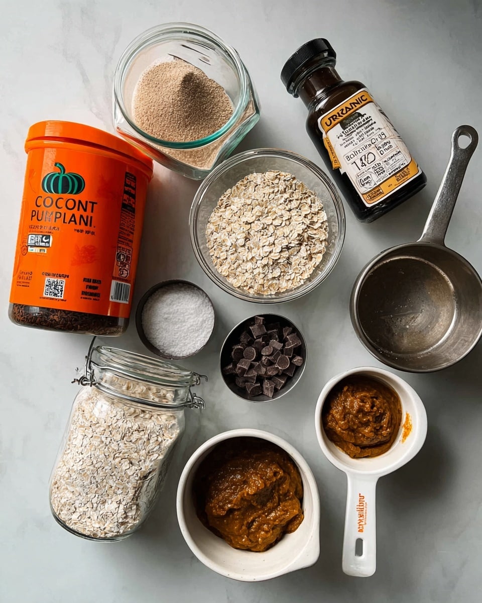 The image shows several baking ingredients arranged on a white marbled surface, including a large container of coconut oil with an orange lid in the foreground. Nearby are a jar of organic pumpkin puree with an orange pumpkin on the label, and a small bottle of dark maple syrup with a cream-colored top and black label. A clear glass container holds a light brown oat mixture, while a metal measuring cup contains dark brown spices. Another metal cup has small dark chocolate pieces, and a glass measuring cup has a tan liquid inside. To the right, there is a white cup with a brown mixture, and next to it a white measuring spoon filled with a thick brown paste. A woman's hand is not visible but elements suggest preparation. The photo was taken with an iphone --ar 4:5 --v 7