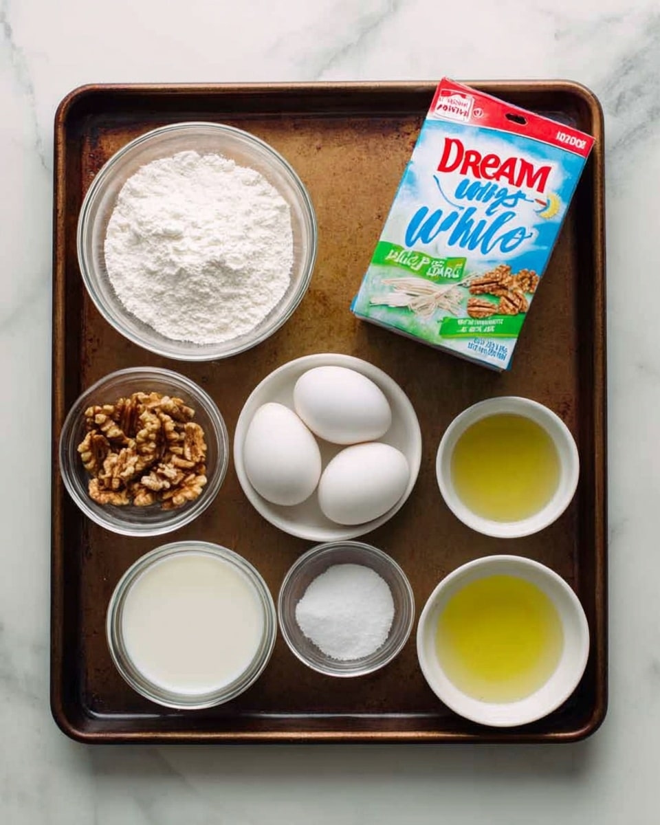 The image shows a dark brown metal baking tray with eight small glass and white bowls arranged neatly on it. From the top left, there is a clear glass bowl filled with white flour, next to it a white bowl with walnut pieces. To the right top corner, there is a colorful box of Dream Whip whipped topping mix. In the middle row at left, a clear glass bowl holding three white eggs. Next to it is a small white bowl with a white powder, likely sugar or salt. On the bottom row, a clear glass bowl with milk is located at the left, next to a small box of Jello pistachio flavor. To the right bottom corner, there are two small white bowls, the left with a clear liquid, probably water, and the right with a light yellow liquid, possibly oil. All bowls are on top of a white marbled surface photo taken with an iphone --ar 4:5 --v 7