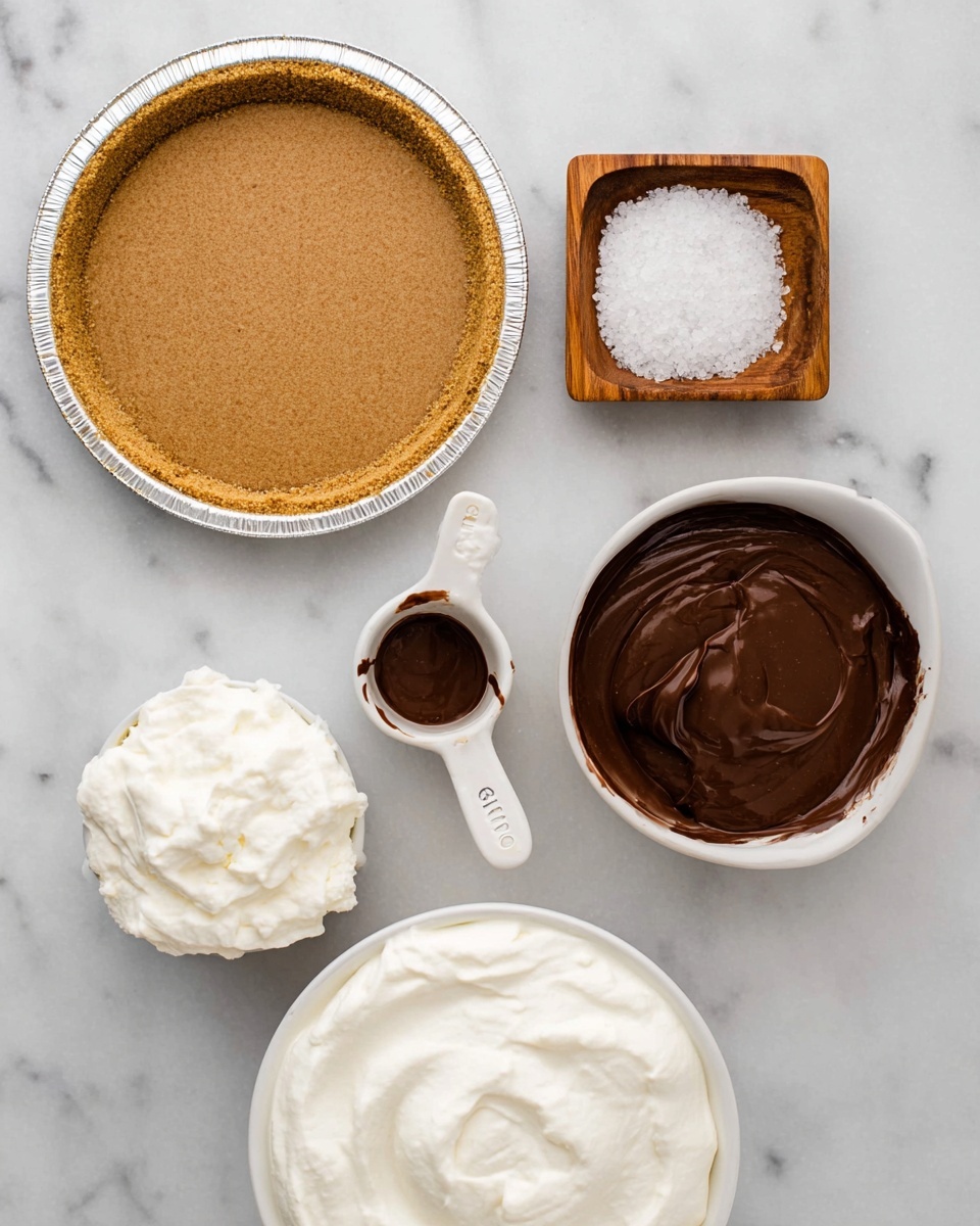 The image shows ingredients laid out on a white marbled surface: a close-up of a graham cracker crust in a silver pie pan with a smooth, light brown texture, a small wooden square bowl filled with thick white cream, a white 1-cup measuring cup filled with melted dark brown chocolate, a smaller white 1/4-cup measuring cup with the same melted chocolate, a small round wooden bowl holding coarse white salt, and a large round white bowl filled with smooth, thick white cream. photo taken with an iphone --ar 4:5 --v 7