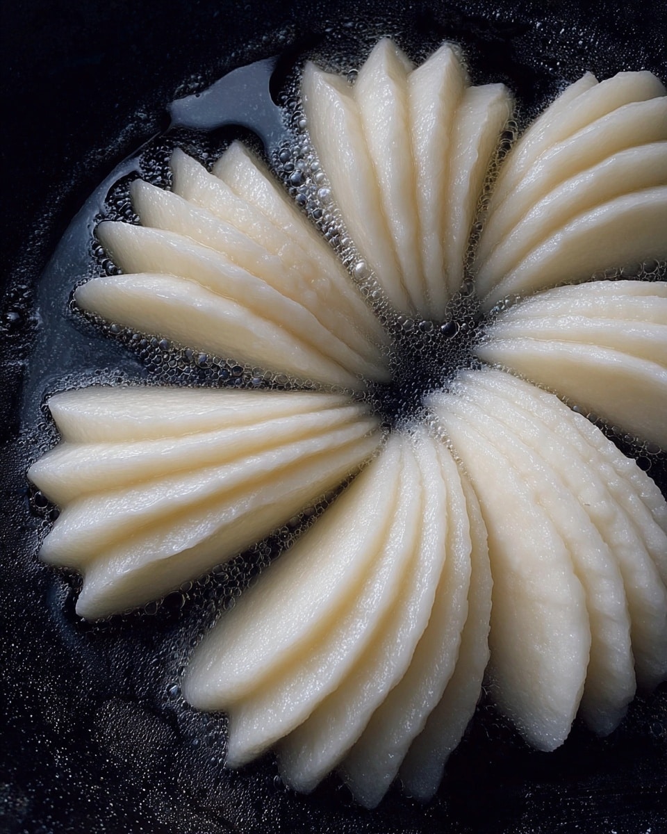 The image shows four sets of thinly sliced white pieces, each arranged in a fanned shape with layers overlapping. These fanned layers are placed in a circular pattern inside a dark pan, with each set pointing towards the center. The slices have a slightly shiny, smooth texture and are uniform in thickness. The background is a black pan with a shiny, slightly wet surface. photo taken with an iphone --ar 4:5 --v 7