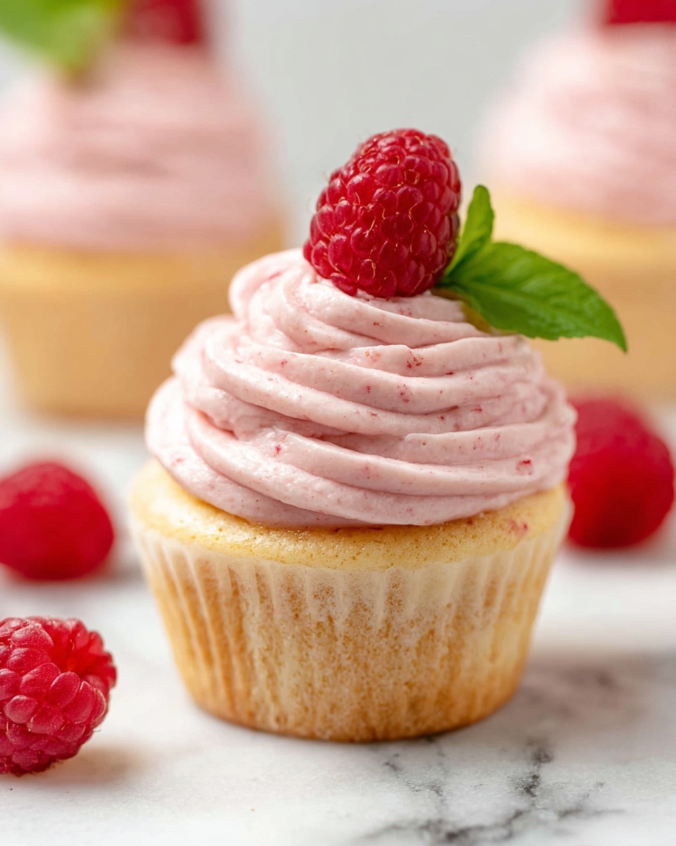 A collage of four images shows the process of making pink frosting in a white bowl on a white marbled surface. The first image shows a white bowl with yellow creamy butter being mixed with a hand mixer, while powdered sugar is being poured in from above. The second image shows more yellow creamy butter being whipped in the bowl with a hand mixer, and a pink spatula holds a dollop of white cream above the bowl. The third image shows the bowl of yellow butter with a spoon holding red jam or puree ready to be added on top of the mixture. The fourth image shows the white bowl filled with smooth pink frosting being mixed with a hand mixer. Photo taken with an iphone --ar 4:5 --v 7