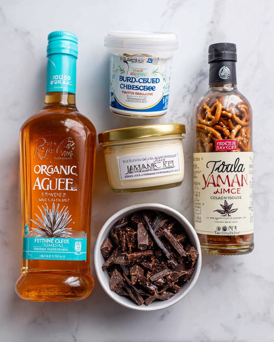 The image shows five different ingredients arranged on a white marbled surface. On the left is a clear plastic bottle filled with amber liquid labeled