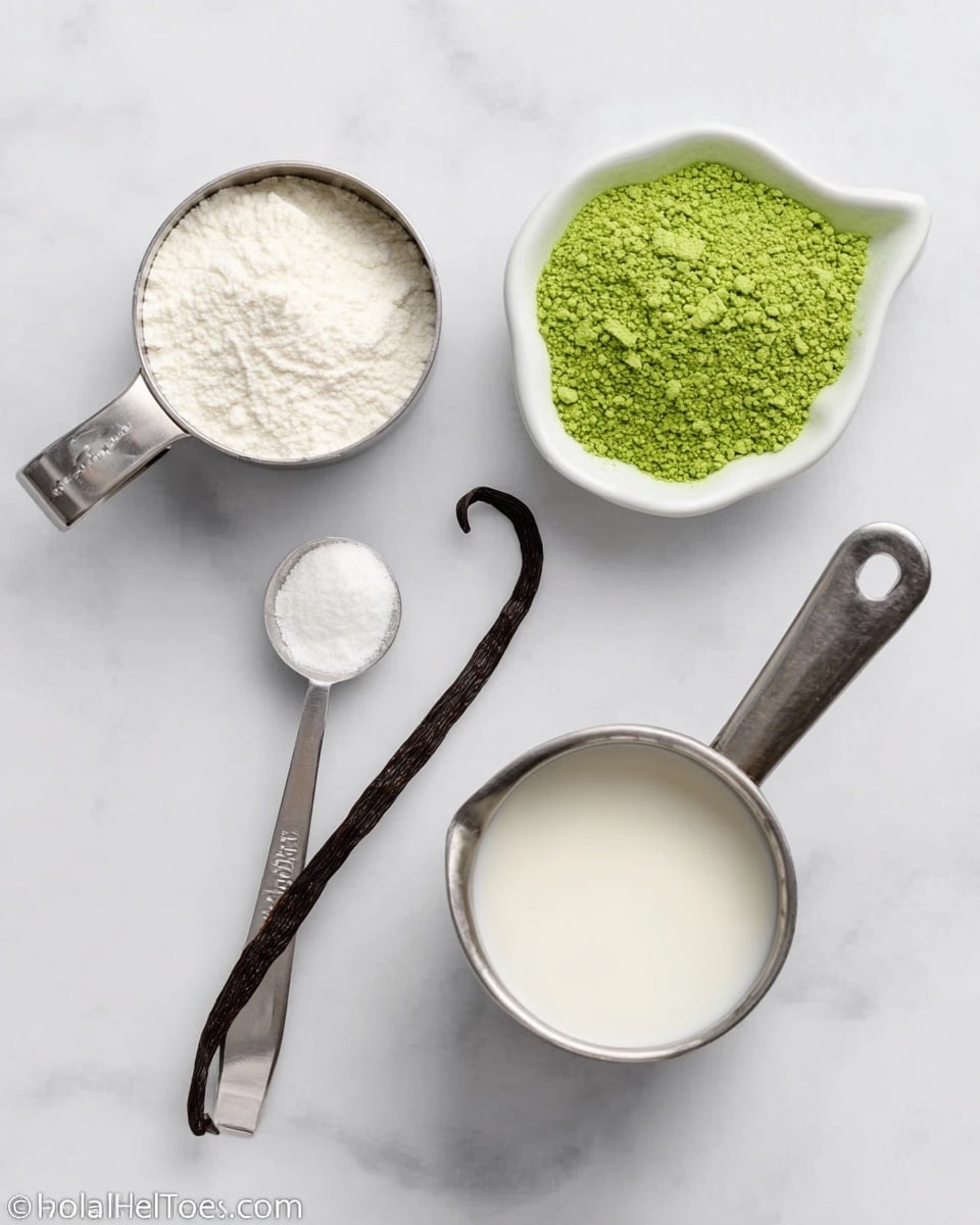 The image shows a white marbled surface with four items arranged on it. There is a small stainless steel measuring cup filled with a white powdery ingredient, a white bowl shaped like a leaf containing bright green powder with a white spoon inside, a brown vanilla bean placed horizontally near the center, and a large stainless steel measuring cup filled with white liquid next to a smaller stainless steel measuring spoon filled with more white liquid. The colors are mostly white, green, brown, and shiny metal, creating a clean and organized look. photo taken with an iphone --ar 4:5 --v 7