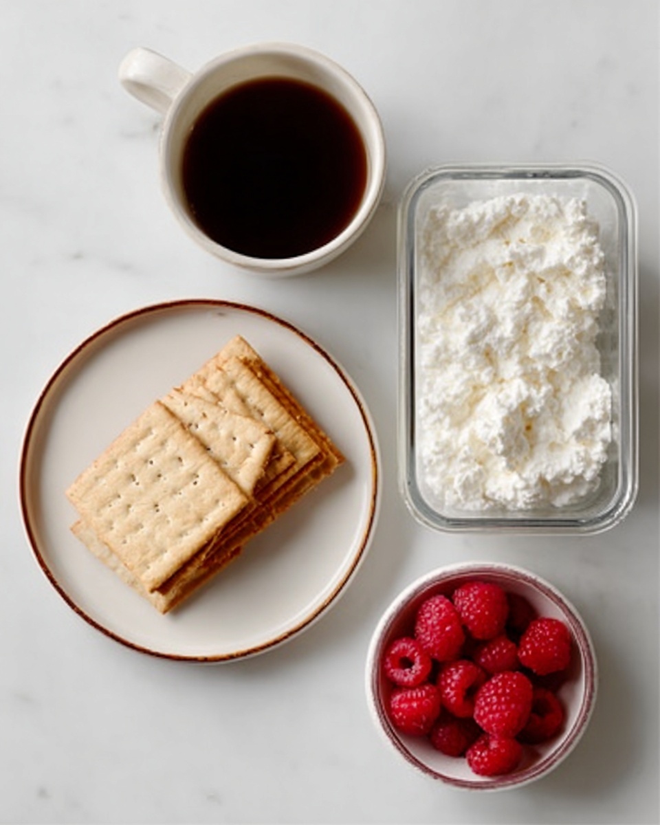A top view of a simple snack setup on a white marbled surface: on the left, a white plate with a thin brown rim holds a neat stack of five rectangular crackers arranged in a slight fan shape; above them to the left, a white cup filled with dark brown liquid, likely coffee; on the right, a clear rectangular glass container filled with a thick white creamy texture that looks like cottage cheese; below it, a small white bowl filled with bright red raspberries creating a strong color contrast. Photo taken with an iphone --ar 4:5 --v 7