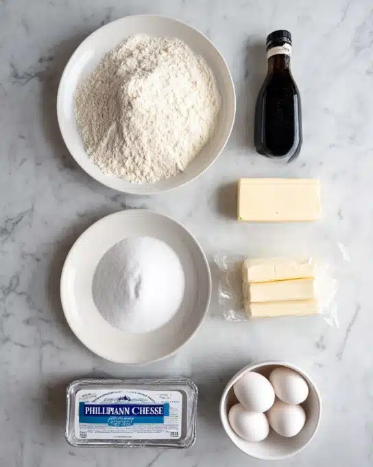 The image shows several baking ingredients neatly arranged on a white marbled surface. At the top left, there is a white plate filled with a mixture of all-purpose flour, baking powder, and salt, all light beige in color with a powdery texture. Below it, there is another white plate holding granulated sugar, which looks fine and white with a small swirl pattern on top. To the right of these plates, there is a black bottle of vanilla extract and two sticks of butter wrapped in light yellow paper. Below the butter, a small white bowl contains four white eggs. At the bottom left corner, a rectangular package of Philadelphia cream cheese is placed with its silver and blue wrapper visible. All items are spaced out evenly, with the white marbled surface visible around them. Photo taken with an iphone --ar 4:5 --v 7