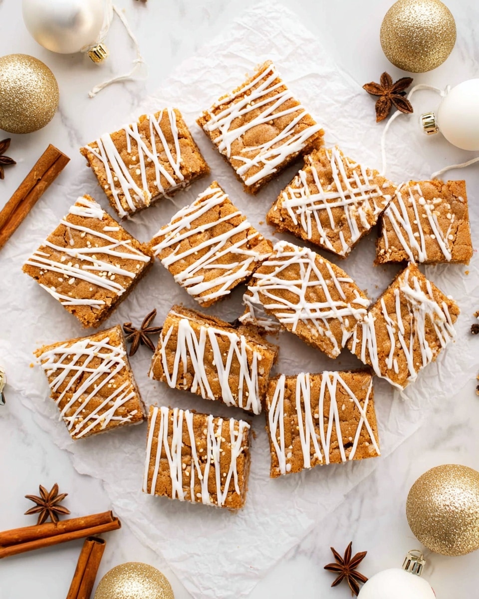 The image shows about sixteen golden-brown square and triangle-shaped cookie bars arranged closely on white parchment paper on a white marbled surface. Each bar has a shiny white drizzle of icing in crisscross patterns across the top. Around the bars, there are a few small cinnamon sticks, star anise, and cloves scattered as decoration. There are also some gold Christmas ornaments and white round objects partly visible on the sides, creating a cozy holiday feel. The scene is bright and clean with soft shadows. photo taken with an iphone --ar 4:5 --v 7