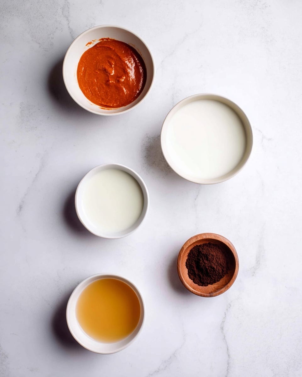 Five small white bowls are placed on a white marbled surface. The top left bowl has a thick, reddish-orange paste with a smooth texture. Below it is a bowl with a white liquid, and next to it on the right is another bowl with a similar white liquid but slightly thicker. At the bottom left, there is a bowl filled with a light amber liquid that looks clear and smooth. To the far right on the surface, there is a small shallow wooden bowl with a mound of dark brown powder inside. The arrangement is simple and clean with soft lighting. photo taken with an iphone --ar 4:5 --v 7