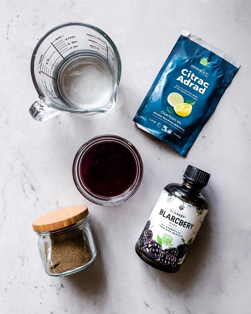 The image shows a top-down view of five items placed on a white marbled surface. In the top left, there is a clear glass measuring cup filled with water, showing measurement markings. Below it is another smaller clear glass measuring cup filled with a dark red liquid. To the right of the cups, there is a blue and white packet labeled
