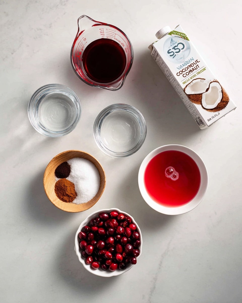 A top-down view of multiple ingredients arranged on a white marbled surface with a carton of vanilla-flavored coconut milk positioned at the top right. To the left, a clear glass measuring cup filled with dark red liquid, and below it, a smaller clear measuring cup contains water. Towards the center right, there is a white bowl with a bright red liquid with a small bubble in the center. Below, a white bowl filled with halved red cranberries is next to a small round light wood bowl holding white granulated sugar. To the left of these, a white bowl with two small piles of brown and dark spice powder sits. The image has a clean and organized look with natural lighting, photo taken with an iphone --ar 4:5 --v 7