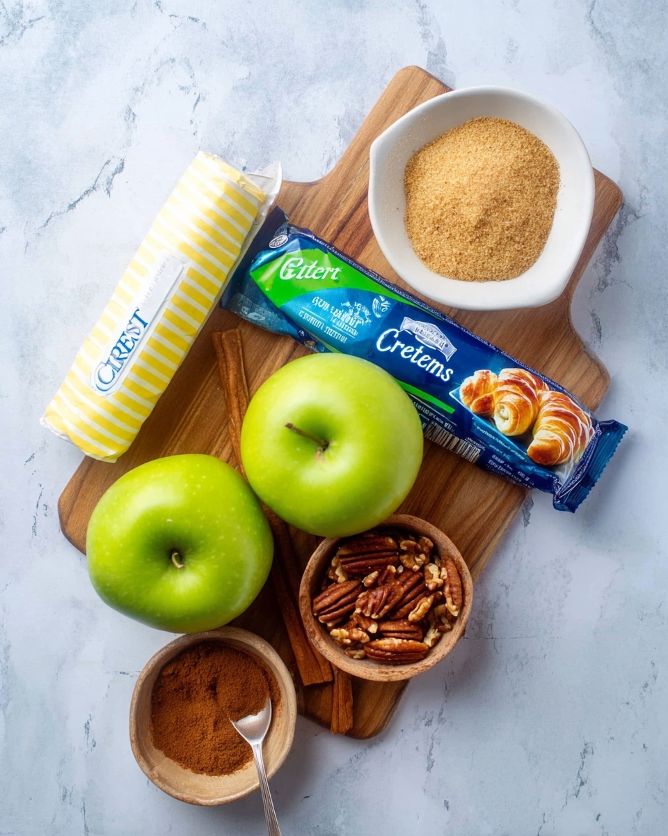 A wooden board on a white marbled surface holds two bright green apples placed side by side, a stick of wrapped butter with blue text, and a rolled-up can of crescents with a blue and green label showing an image of baked crescent rolls. Above the board, there is a white bowl with yellow stripes filled with light brown sugar, a small white bowl with chopped pecans, a tiny wooden bowl with cinnamon powder, and a small metal spoon also holding cinnamon powder. The arrangement is neat and well-lit, showing the texture and colors clearly. Photo taken with an iphone --ar 4:5 --v 7