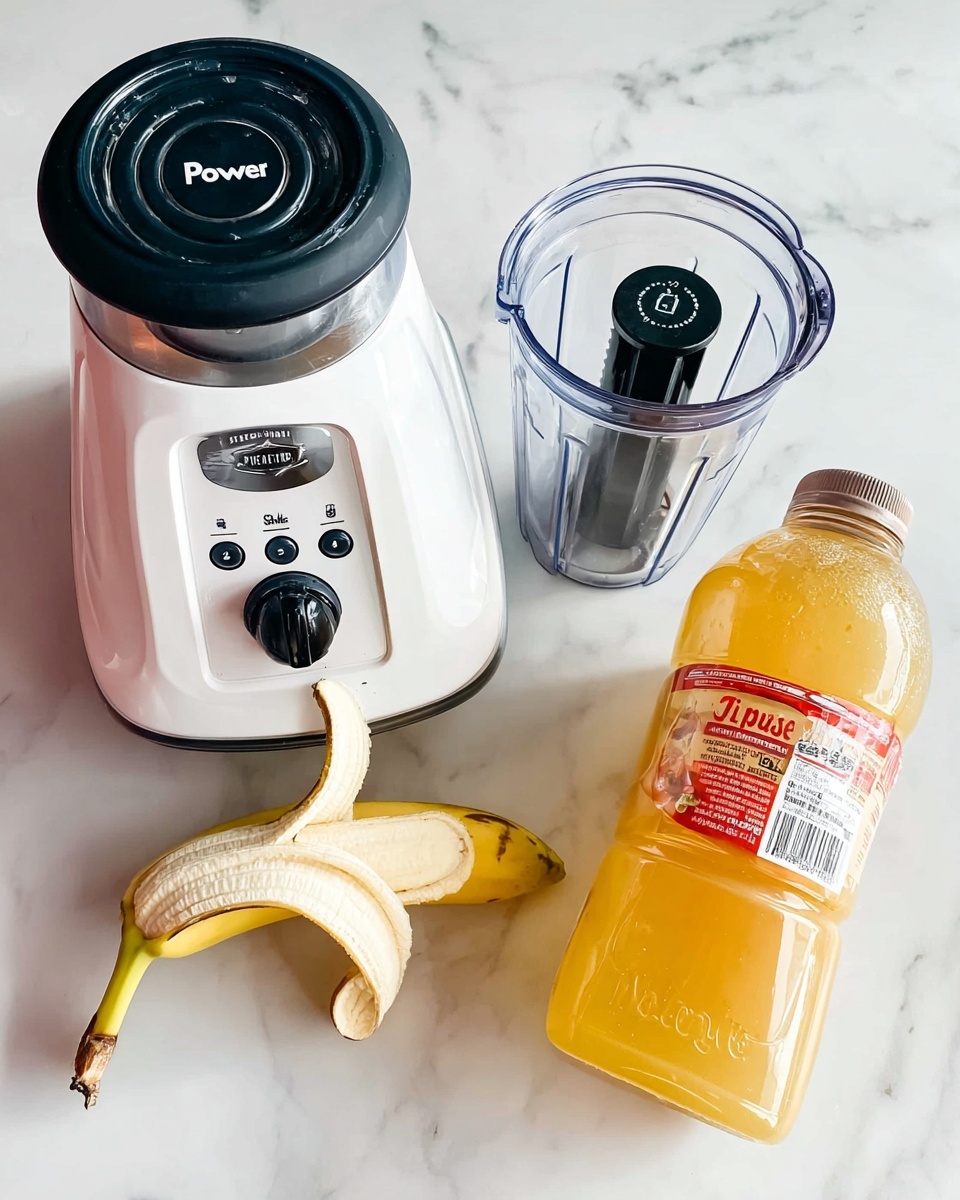 The image shows a white blender base with a black top and buttons labeled