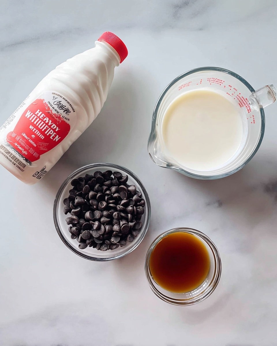 A white marbled surface holds four items: a white and red bottle of heavy whipping cream on the left, a small clear glass bowl in the center filled with dark chocolate chips, a clear measuring cup filled with creamy white liquid at the top right, and a tiny clear bowl at the bottom center containing a small amount of brown vanilla extract liquid photo taken with an iphone --ar 4:5 --v 7
