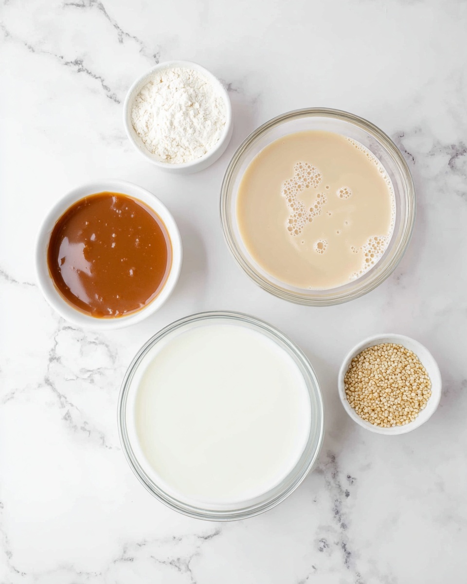The image shows five small bowls with different ingredients placed on a white marbled texture surface. In the bottom center, there is a large transparent bowl filled with smooth white liquid. Above it to the right is a medium transparent bowl containing a light cream-colored liquid with some bubbles on the surface. To the left of this bowl, there is a small white bowl filled with a shiny caramel-colored sauce. Above that, another small white bowl contains fine white powder. To the upper right corner, there is a tiny white bowl holding small beige grains. The setup is simple and clean, with all containers neatly arranged and clearly showing the textures and colors of each ingredient photo taken with an iphone --ar 4:5 --v 7