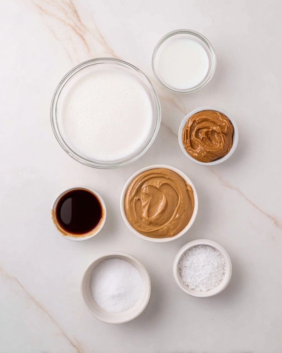 The image shows seven small bowls with different ingredients arranged on a white marbled surface. At the top center is a clear bowl filled with white liquid. Below it to the left is another clear bowl with a foam-covered white liquid. To the right of the top bowl is a small white bowl filled with smooth brown peanut butter. Next to it on the left is a small brown bowl with a thick tan sauce. Below these bowls are three smaller bowls lined up: a white bowl on the left with dark brown liquid, a clear bowl with fine white powder in the center, and a very small white bowl filled with coarse white salt to the right. The bowls are neatly spaced and all the colors and textures of the ingredients are clearly visible. Photo taken with an iphone --ar 4:5 --v 7