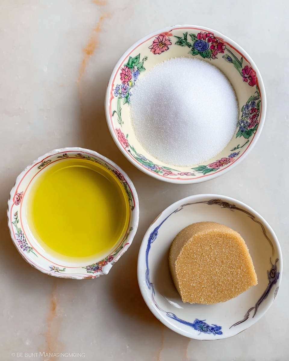 The image shows three small white bowls with colorful floral patterns on a white marbled surface. The top right bowl is filled with a mound of fine white sugar, the bottom right bowl holds a round block of light brown sugar, and the left bowl contains a clear, bright yellow liquid, likely oil, with a smooth shiny texture. The arrangement is simple and clean, with the bowls spaced evenly apart. photo taken with an iphone --ar 4:5 --v 7