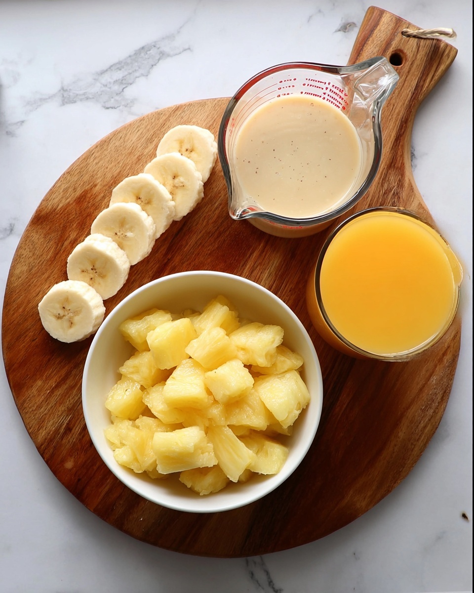 A white bowl filled with small chunks of yellow frozen pineapple sits on the lower left side of a round wooden board with a handle. To the upper left on the wooden board are several sliced banana pieces arranged in a loose line. On the upper right side of the board, there is a clear glass measuring cup filled with a light beige liquid, and just below it to the right is a clear glass filled with bright orange juice. The background is a white marbled surface. photo taken with an iphone --ar 4:5 --v 7
