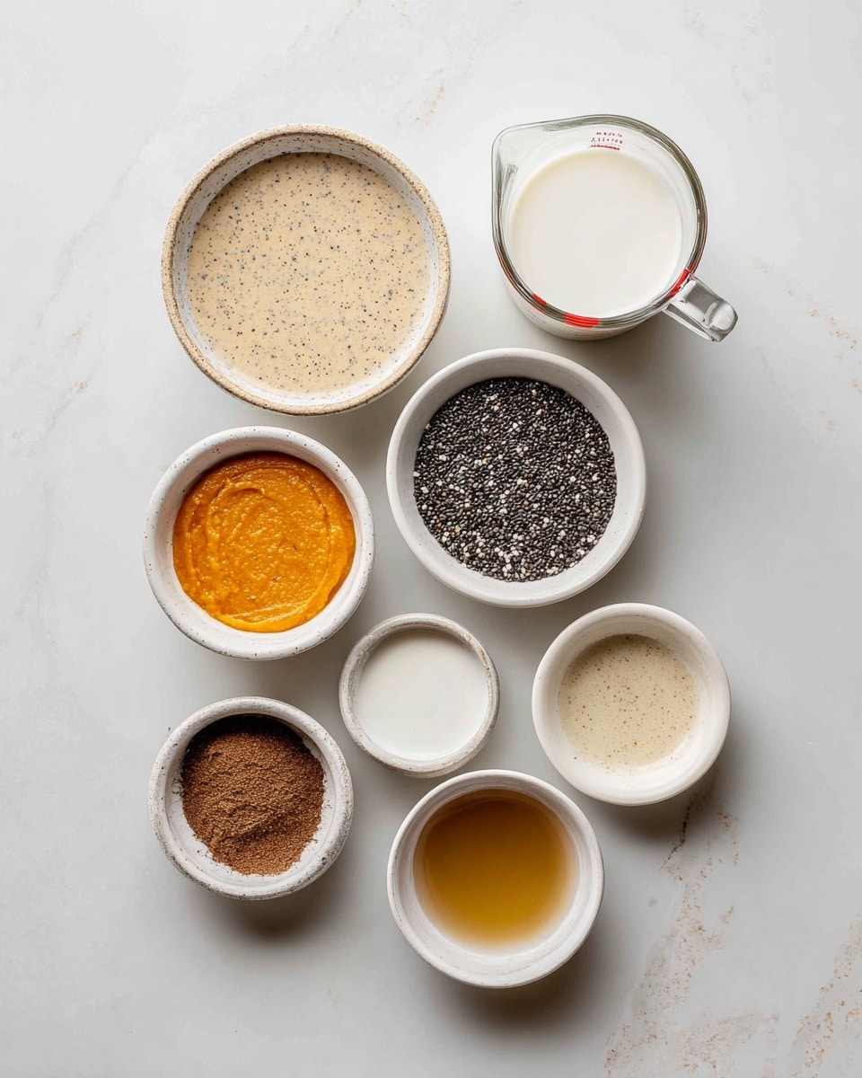 The image shows eight small white bowls and a glass measuring cup arranged on a white marbled surface. The measuring cup at the top right contains a white liquid, likely milk. Below it, the top left bowl holds a creamy, light brown mixture with visible specks. In the center left, a white bowl is filled with tiny black and white chia seeds. To the right of that, a small white bowl holds bright orange smooth puree. The bottom left white bowl contains a brown powdered spice. At the bottom center, a white bowl is filled with a white liquid, possibly cream or yogurt. To the right, another white bowl contains a golden-brown liquid. At the far right center, a small white bowl also holds a similar golden liquid. All items are neatly placed with soft lighting, and the scene appears clean and organized. Photo taken with an iphone --ar 4:5 --v 7
