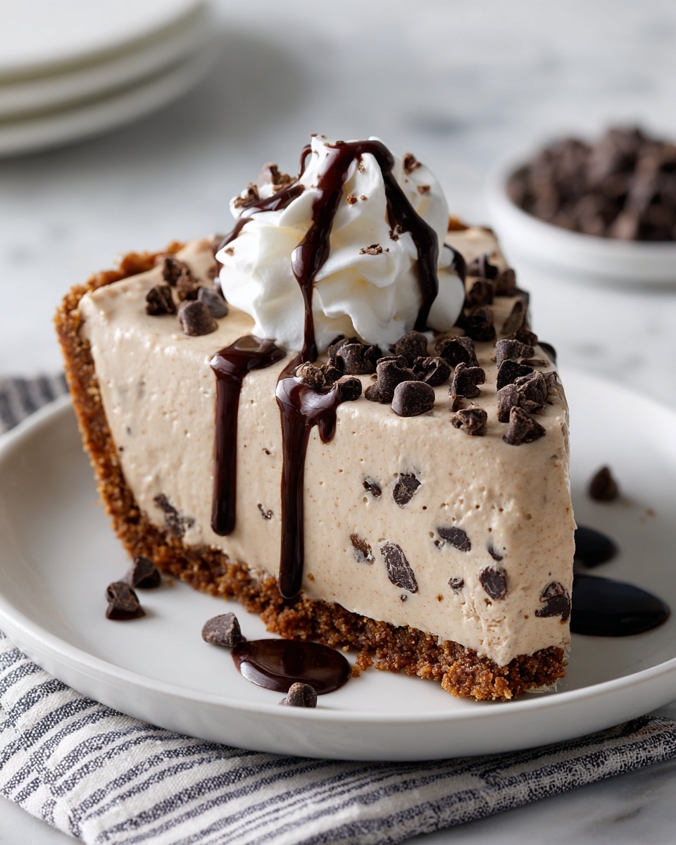 A slice of creamy dessert sits on a white plate over a white marbled surface, with three distinct layers: the bottom layer is a golden brown crumbly crust, the thick middle layer is light beige with chocolate bits mixed throughout, and the top layer features a soft white whipped cream dollop drizzled with thin, dark chocolate lines. A silver fork rests next to the slice on the plate, and more dessert pieces blurred in the background. photo taken with an iphone --ar 4:5 --v 7