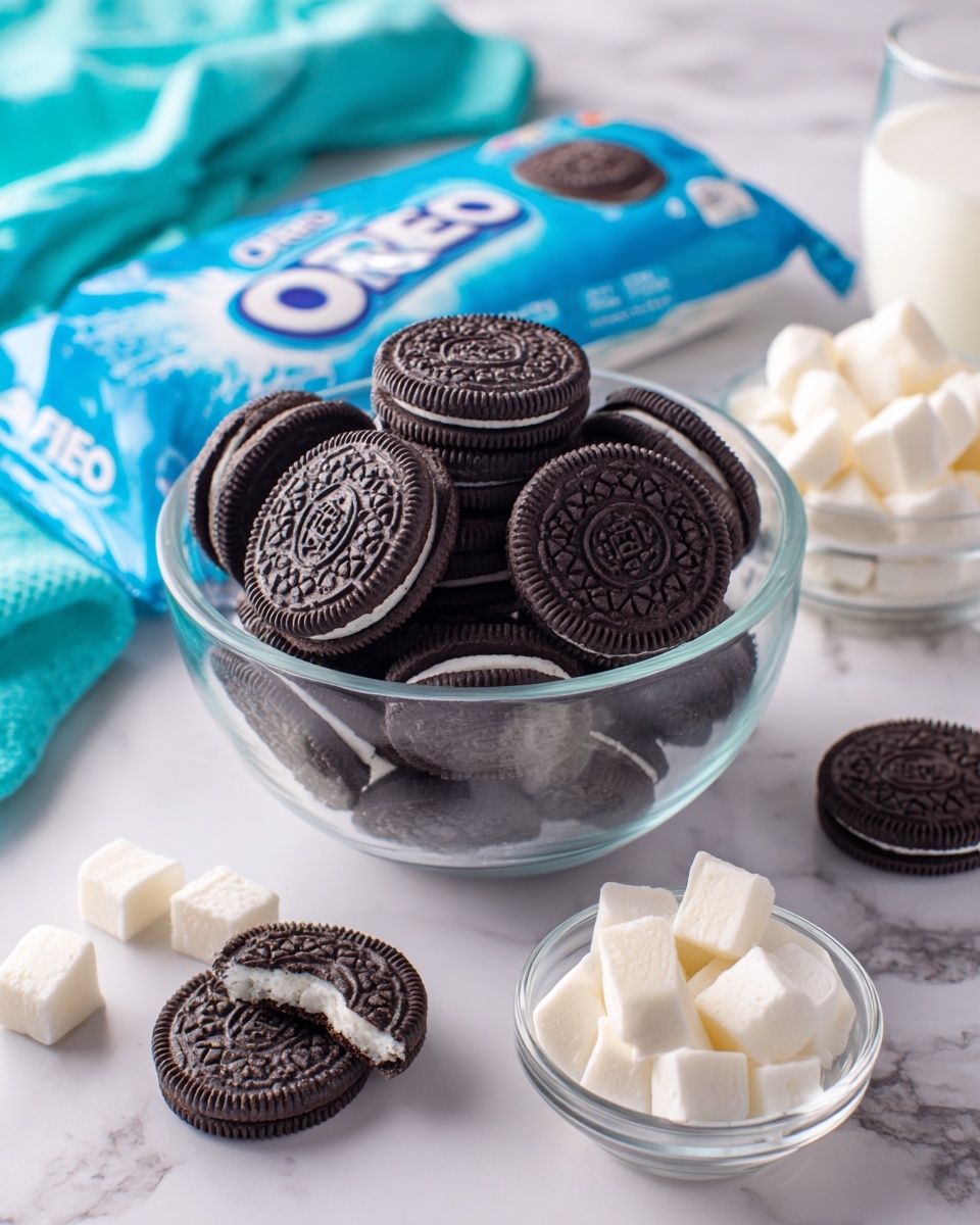 The image shows a clear glass bowl full of Oreo cookies stacked in different directions at the center. Above the bowl is a blue Oreo package with white and light blue text and graphics. Around the bowl, several Oreo cookies lie flat on a white marbled surface, with one cookie broken to show its white cream inside. Below the bowl, there is a small clear glass bowl filled with white cream cubes. Next to it, there is another clear glass bowl filled with milk. A bright turquoise cloth is partially visible on the left side, adding a pop of color to the scene. The photo taken with an iphone --ar 4:5 --v 7