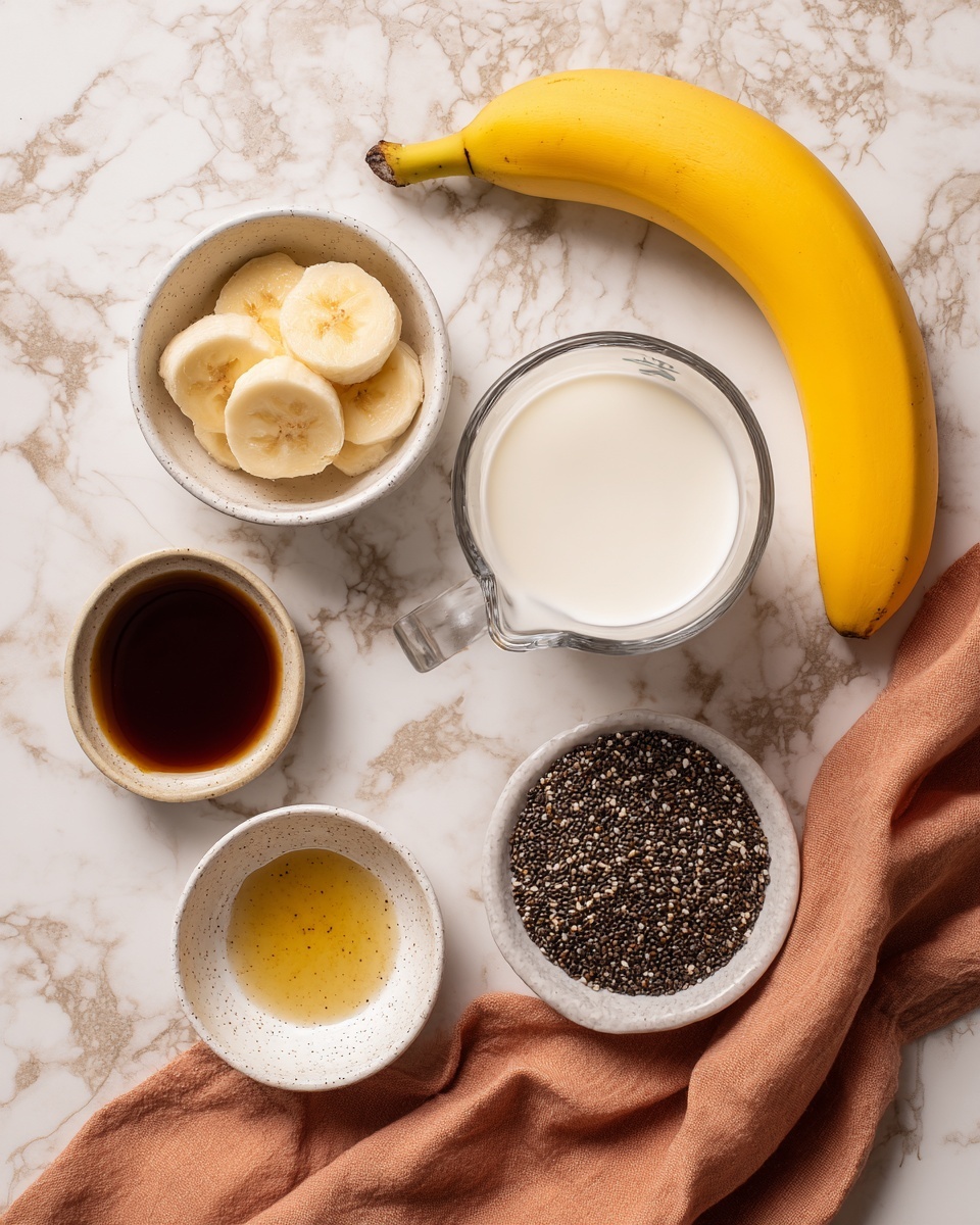 The image shows ingredients arranged on a white marbled surface: a whole yellow banana at the top, a white bowl with peeled banana pieces on the left, a glass measuring cup filled with white milk on the right, a small brown bowl with dark syrup near the bottom left, a small white speckled bowl holding a light golden liquid nearby, and a white bowl filled with black chia seeds with a peach-colored cloth draped next to it. Photo taken with an iphone --ar 4:5 --v 7