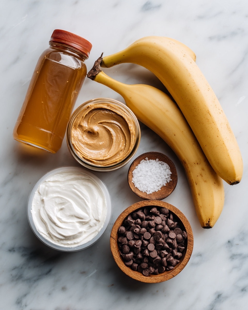The image shows six food items laid out on a white marbled surface. There is a clear plastic bottle filled with golden honey on the left, next to a jar with a red lid containing smooth light brown peanut butter. To the right, there are two ripe yellow bananas with some brown spots at the top. Below these, there's a small wooden bowl with coarse white salt, a round white container of Greek yogurt sealed with a clear plastic film, and a shiny golden bag of semi-sweet chocolate chips with some chocolate chips scattered on the bag. photo taken with an iphone --ar 4:5 --v 7