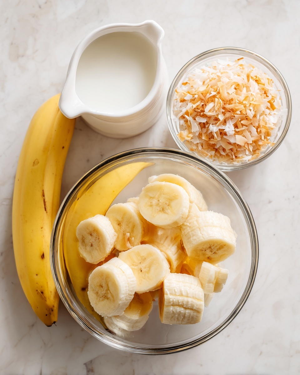 The image shows three clear glass containers on a white marbled surface. The largest bowl at the bottom center holds peeled yellow bananas, some whole and some broken into halves. To the top left is a small white pitcher filled with a white liquid, and to the right is a small clear bowl holding golden toasted coconut flakes. The overall setting is simple with a bright and clean look. photo taken with an iphone --ar 4:5 --v 7