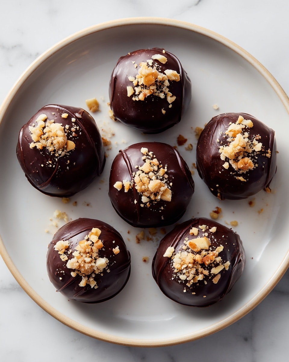 Eight round dark chocolate balls sit on a white plate with fine ridges near the edge, each topped with several small pieces of light brown and white nuts. The chocolates have a slightly glossy, smooth texture with soft swirls and folds. They are arranged loosely in a circular pattern on a white marbled surface background. The overall look is rich and handmade, with a mix of dark brown and light nut colors. photo taken with an iphone --ar 4:5 --v 7