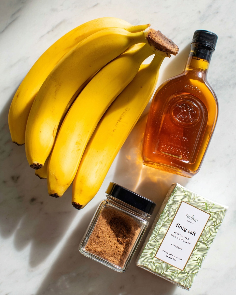 A bunch of five ripe yellow bananas is placed on the top left of the frame, with smooth bright yellow skin and slight brown spots. To the right of the bananas, there is a clear plastic bottle of maple syrup with a black cap, the amber syrup visible inside. Below the bananas, on the bottom left, sits a small square glass jar filled with brown cinnamon powder and a black lid. Next to the cinnamon jar on the bottom right is a white box with green geometric patterns labeled