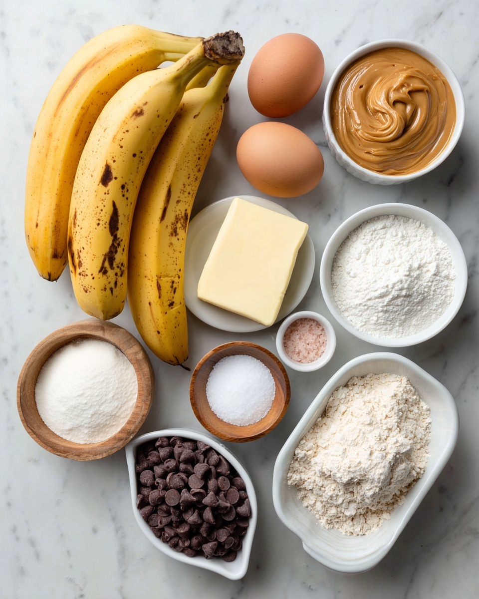 A flat layout of baking ingredients on a white marbled surface includes three yellow bananas with some brown spots on the left, two brown eggs below the bananas, and a stick of butter in the center. Near the bananas is a white bowl filled with smooth light brown peanut butter. Around the central items, there are small white bowls holding white sugar, brown sugar, creamy white sour cream, white powdered sugar, white flour, and white salt. A small wooden bowl with light pink salt sits near the eggs. On the bottom center, a white oval dish contains dark chocolate chips. All bowls and dishes are white on a white marbled background. Photo taken with an iphone --ar 4:5 --v 7