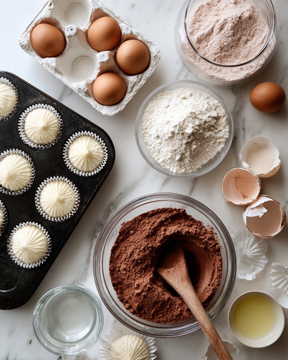 The image shows a white marbled surface with baking supplies neatly arranged for making cupcakes. On the left, there is a black muffin tray lined with white paper cupcake liners, and several more white liners scattered nearby. Toward the top center, there are three brown eggs resting in a white egg tray. Below that, a large clear glass measuring jug holds light pink dry ingredients, while next to it on the right, a big clear bowl contains a darker brown powder mix being stirred with a wooden spoon. At the top right, a smaller glass bowl holds two cracked eggs, and a small clear bowl with a pale yellow liquid sits nearby. A clear glass jug of water is also placed toward the upper center. The setup looks ready for mixing and baking cupcakes. photo taken with an iphone --ar 4:5 --v 7