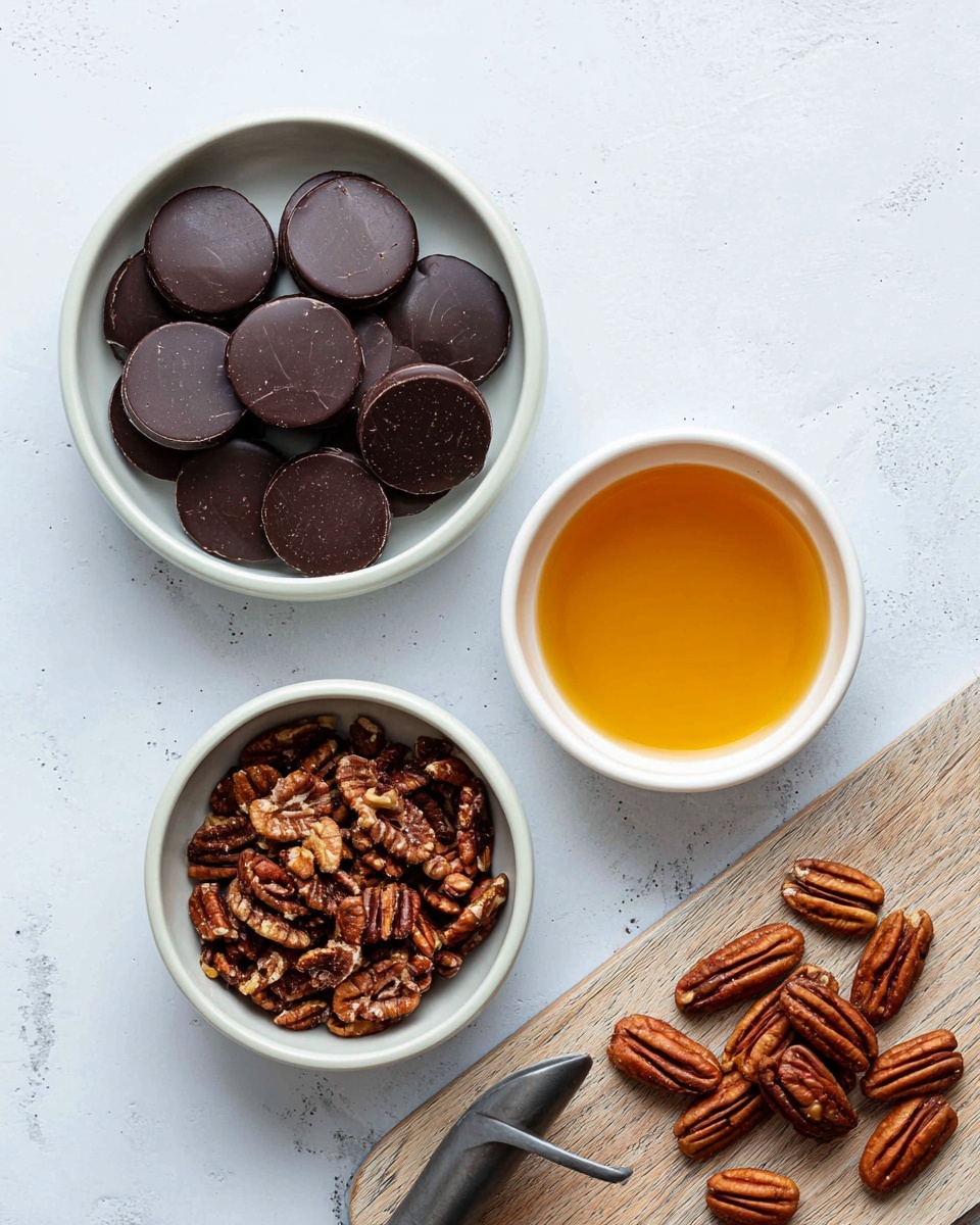 The image shows a white bowl filled with round, dark chocolate pieces that have a smooth and slightly shiny surface, sitting on a white marbled background. Next to it is a small white bowl containing a golden amber liquid. Below these bowls is another white bowl filled with chopped pecans that have a rich brown color and a textured surface. To the right is a light wooden cutting board with a pile of whole pecans and a curved metal chopping tool resting on it. The overall scene is clean and organized with clear textures and colors. photo taken with an iphone --ar 4:5 --v 7